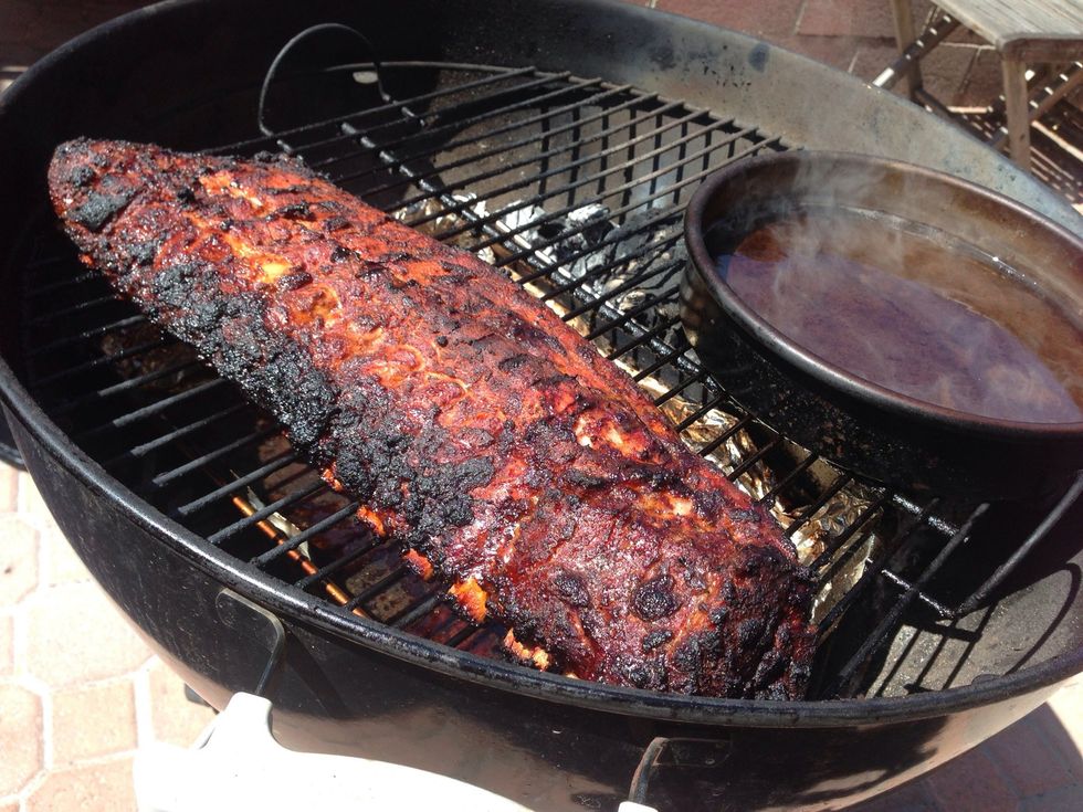 After 2 hours, take the ribs and wrap in a double layer of foil, making somewhat of a package. Pour the splash of apple juice and bourbon in the package and include the butter as well. Seal\u2026