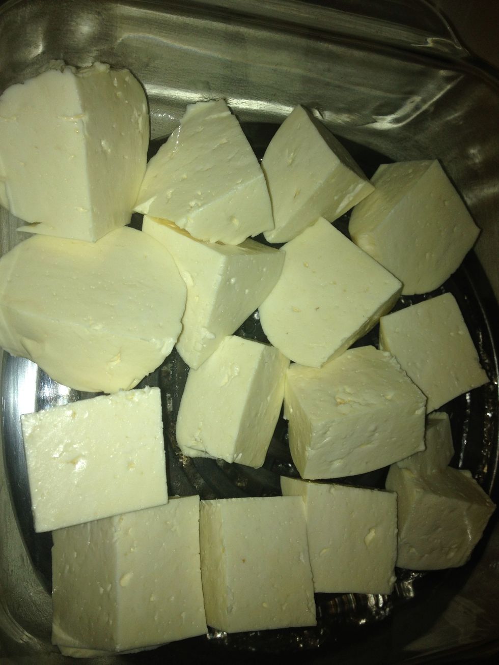 After 24 hours of hang drying cheese, cut cheese into 1-2" blocks apply salt on all sides.