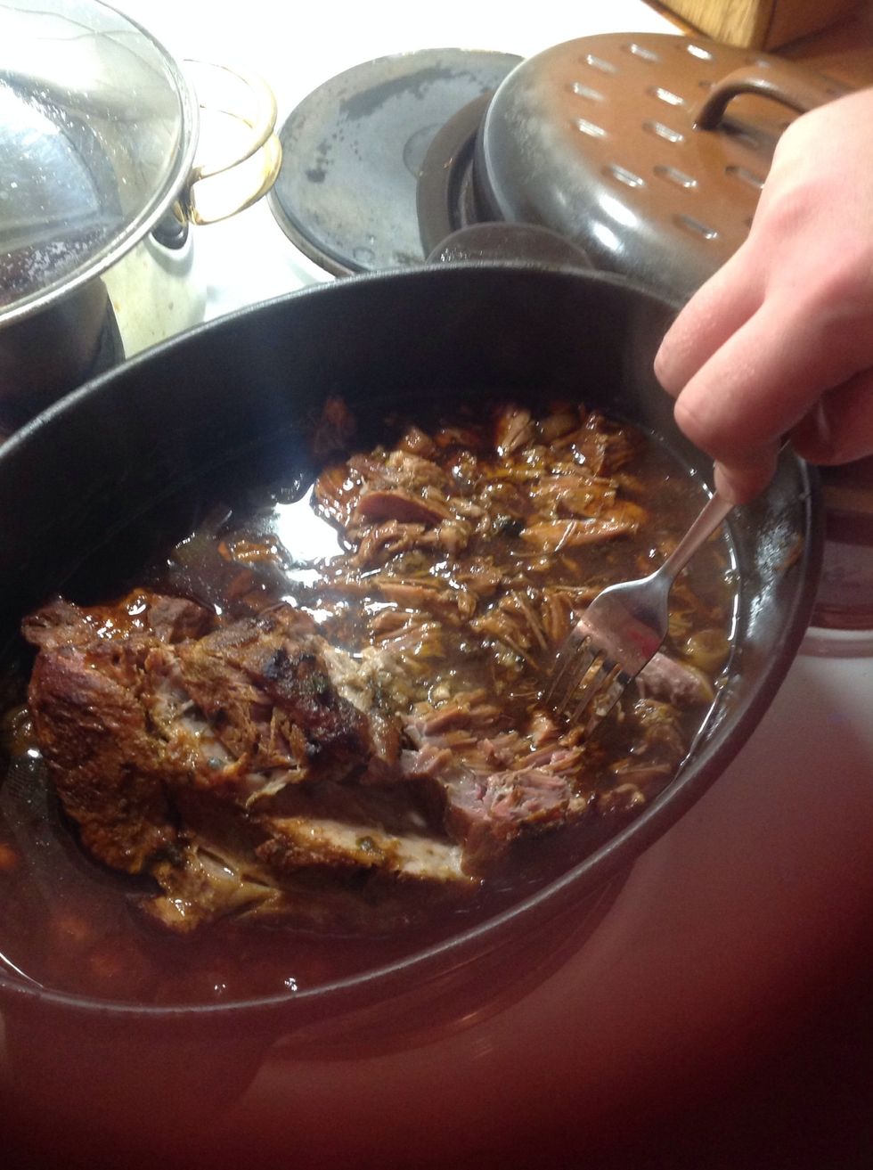 After 3-4 more hours in the oven, use two forks to divide the meat into "strings".