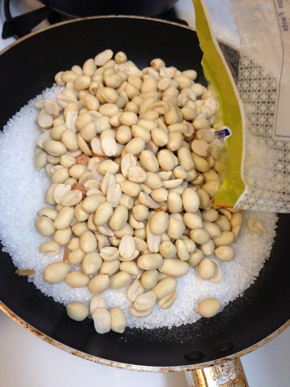 After 3-5 min, pour the peanuts to the pan.