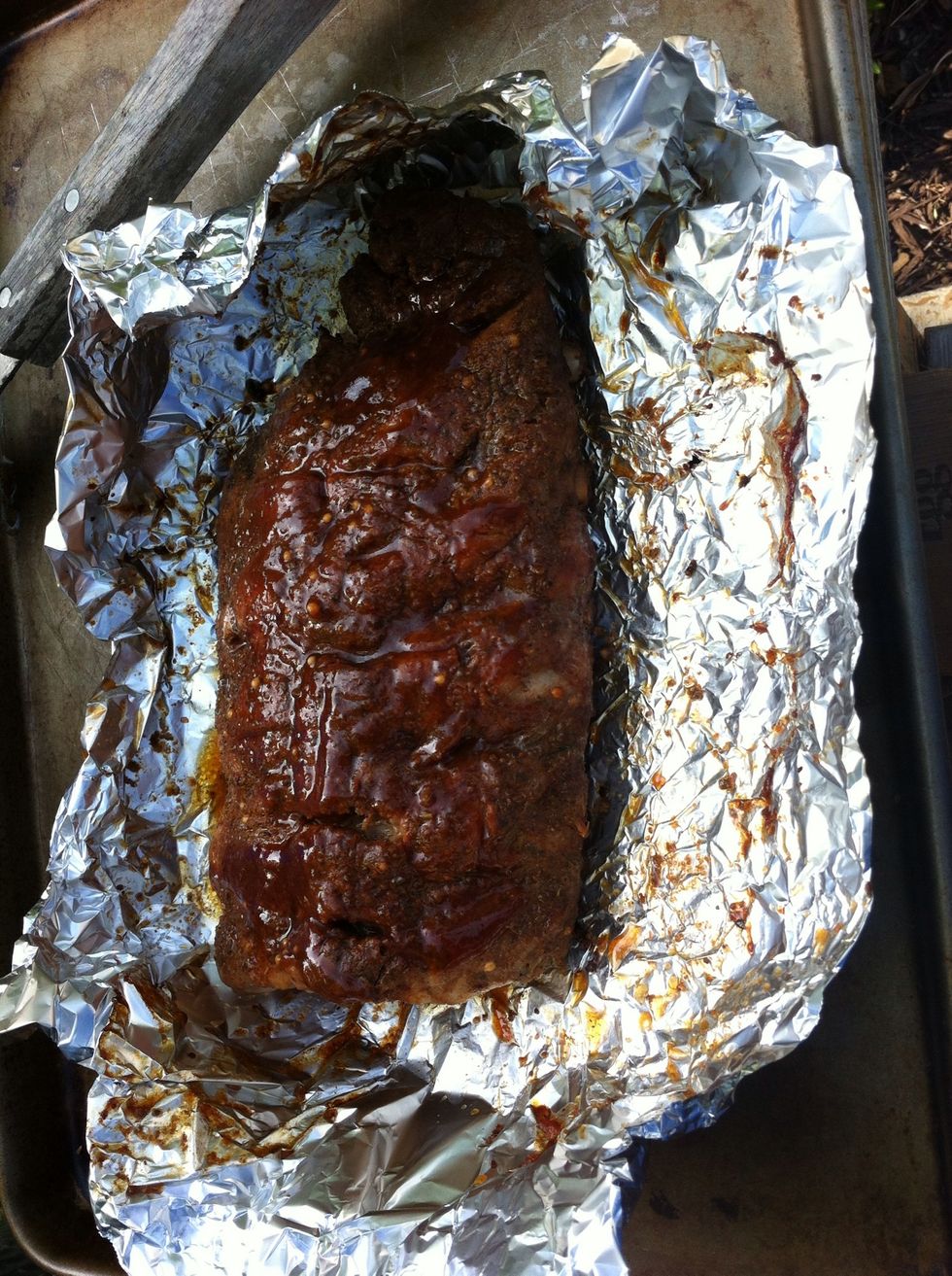 After 3 hours of cooking turn ribs and brush BBQ sauce on the other side this time. Back on grill at 250-275 for 30 min. After 30 min. Close vents and let the temperature drop for 30 min.