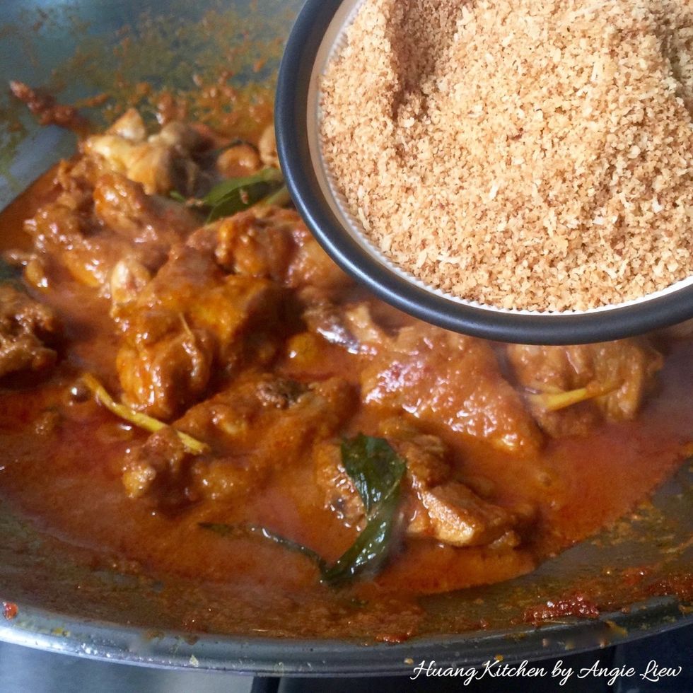 After 30 minutes, add kerisik (toasted coconut) and stir well to incorporate into the chicken rendang gravy.