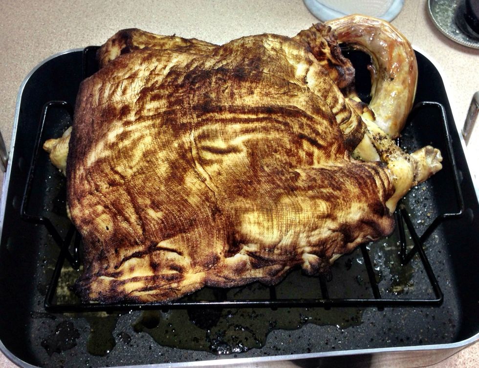 After 30 minutes remove the turkey from the oven and turn the oven temperature down to 350 degrees. Baste the bird with more of the wine/butter mixture. The cheesecloth will get quite dark in colour.