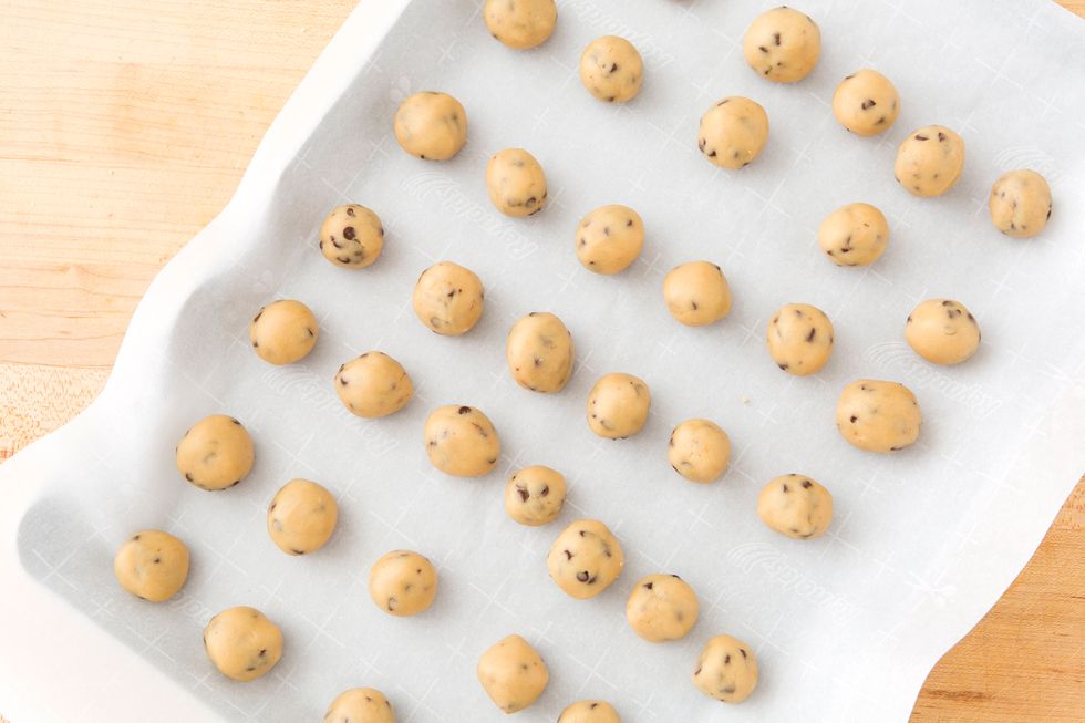 After 30 minutes, your dough should be firm enough to roll into 1 inch balls. Place the dough balls on a cookie sheet lined with parchment paper. Place back in the fridge for 30 minutes to firm.
