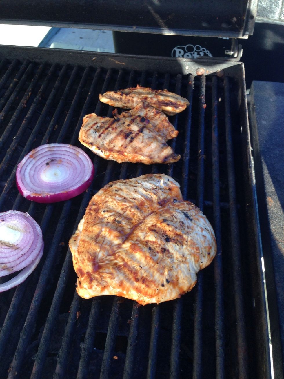 After 4 minutes, flip the chicken. You can tell it's ready because the edges will be white. When you flip the chicken, flip the onions as well. :)
