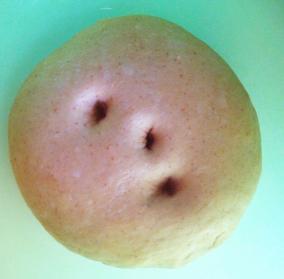 After 45 minutes, check how much the dough has risen by poking it with a finger. Punch down and hand-knead lightly with just enough flour to prevent dough from sticking to the board.