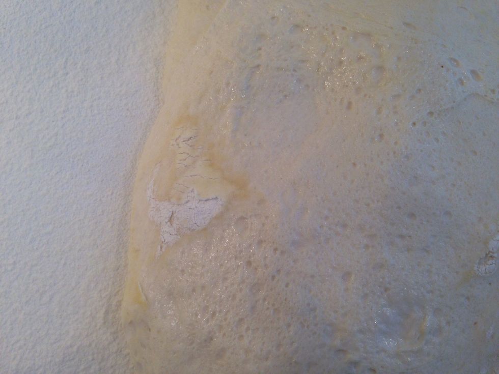 After 45 minutes, the dough will have risen slightly. Turn it onto the counter. Here is an example of something you don't want in your bread- a lump of Pam soaked flour. Pinch that right out.