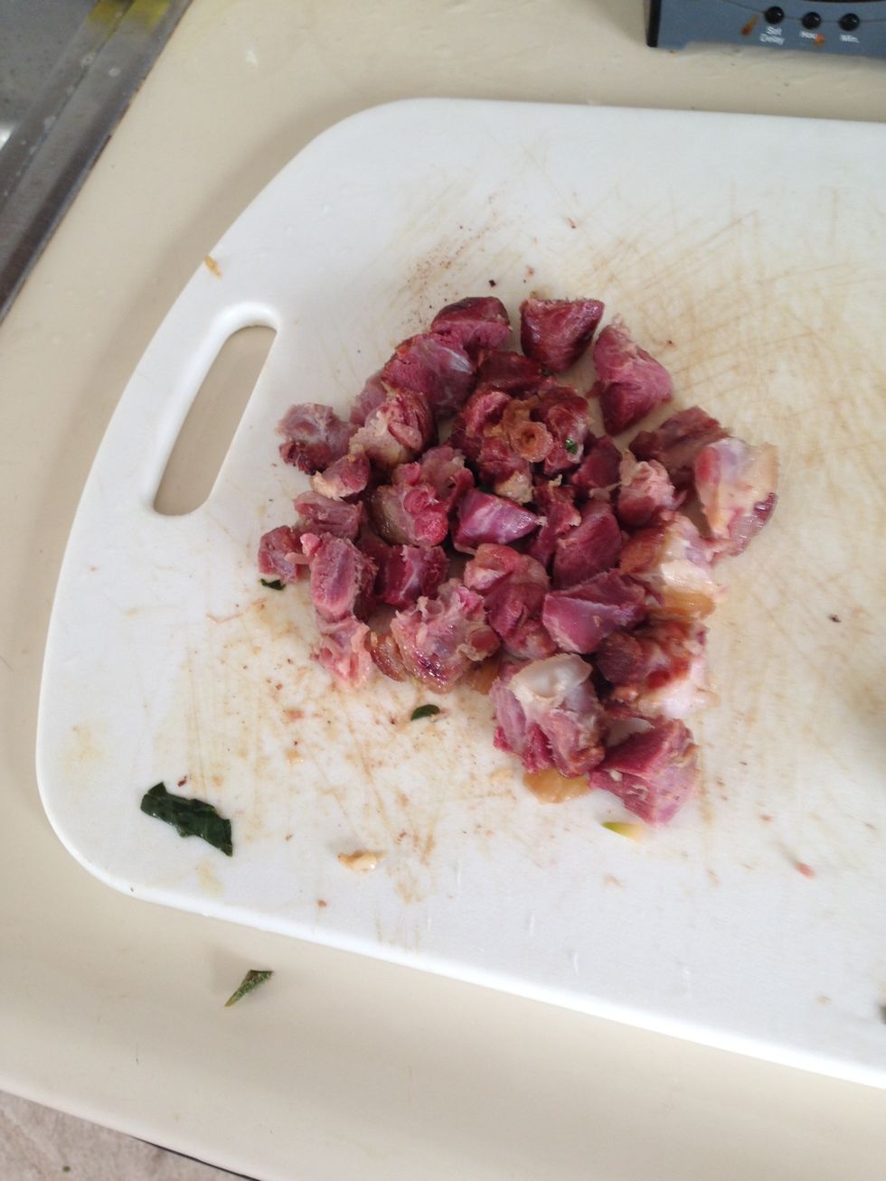 After 5 minutes, pull out the ham hocks and leave the rest to simmer a bit longer. Ham hocks don't have much meat, so get what you can off and dice it. Discard the fatty skin.