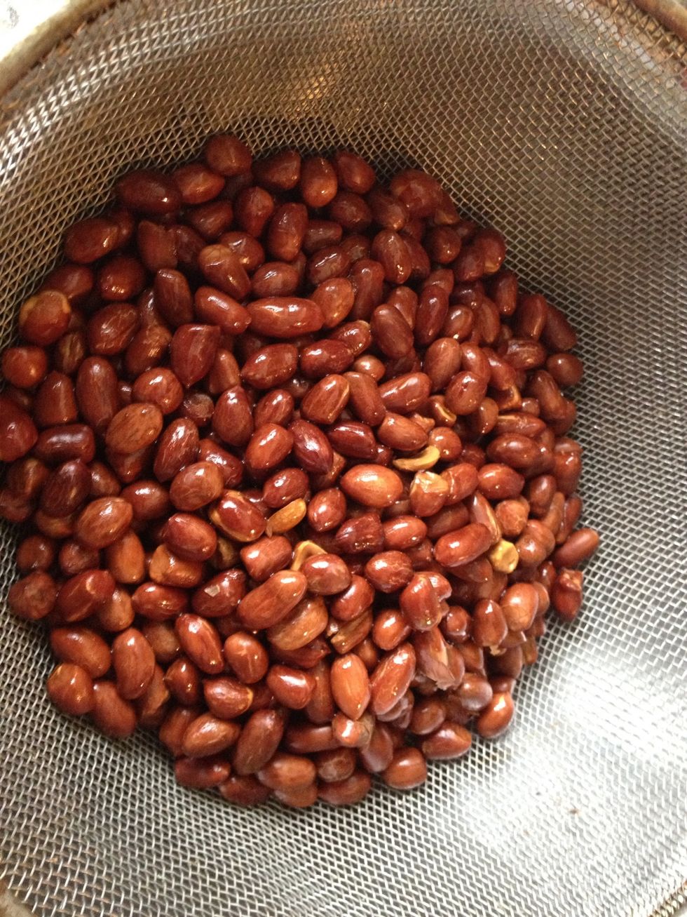 After 5 minutes, remove peanuts from oil and place in strainer or colander to drain excess oil.