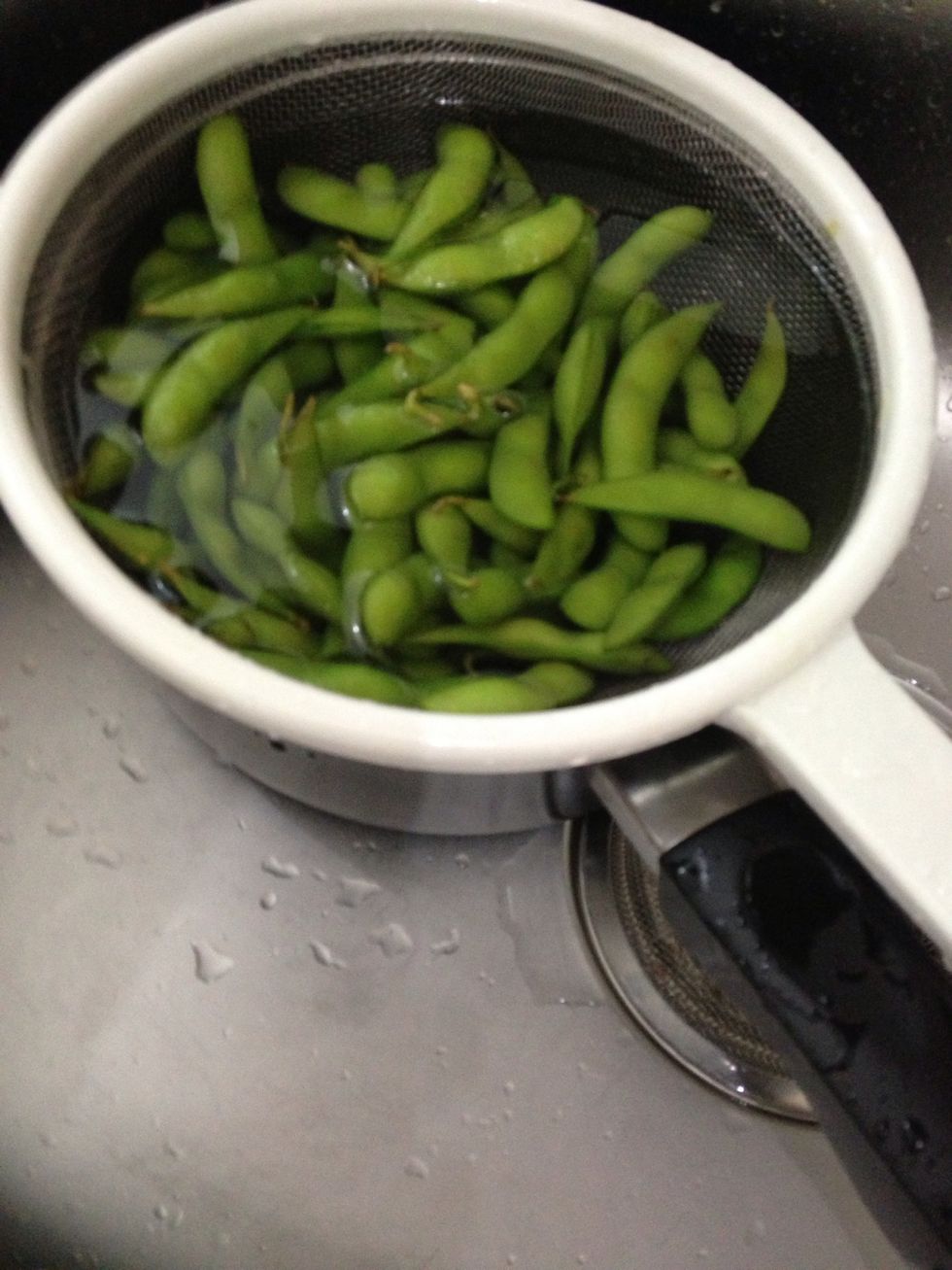 After 5 minutes, run the edamame by some cold ways to shock the greens and stop them from cooking any further (and to keep th green)