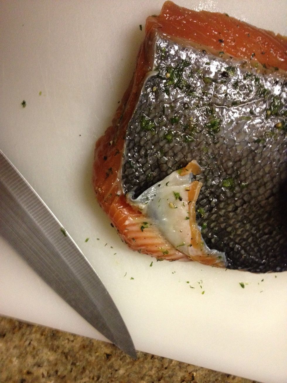 After 72 hours scrape curing mix off fish. Using a sharp knife cut the skin off without slicing up the flesh, start at a corner and work your way across