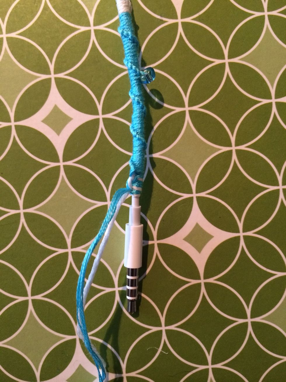 After a few ending knots let's cut the extra string off and add a little bit if glue to finish this off.