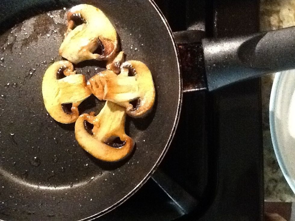 After a few minutes, you'll notice a sheen of moisture over the mushrooms. This is liquid being expelled from the mushrooms. Add a pinch of salt if you don't see this sheen.