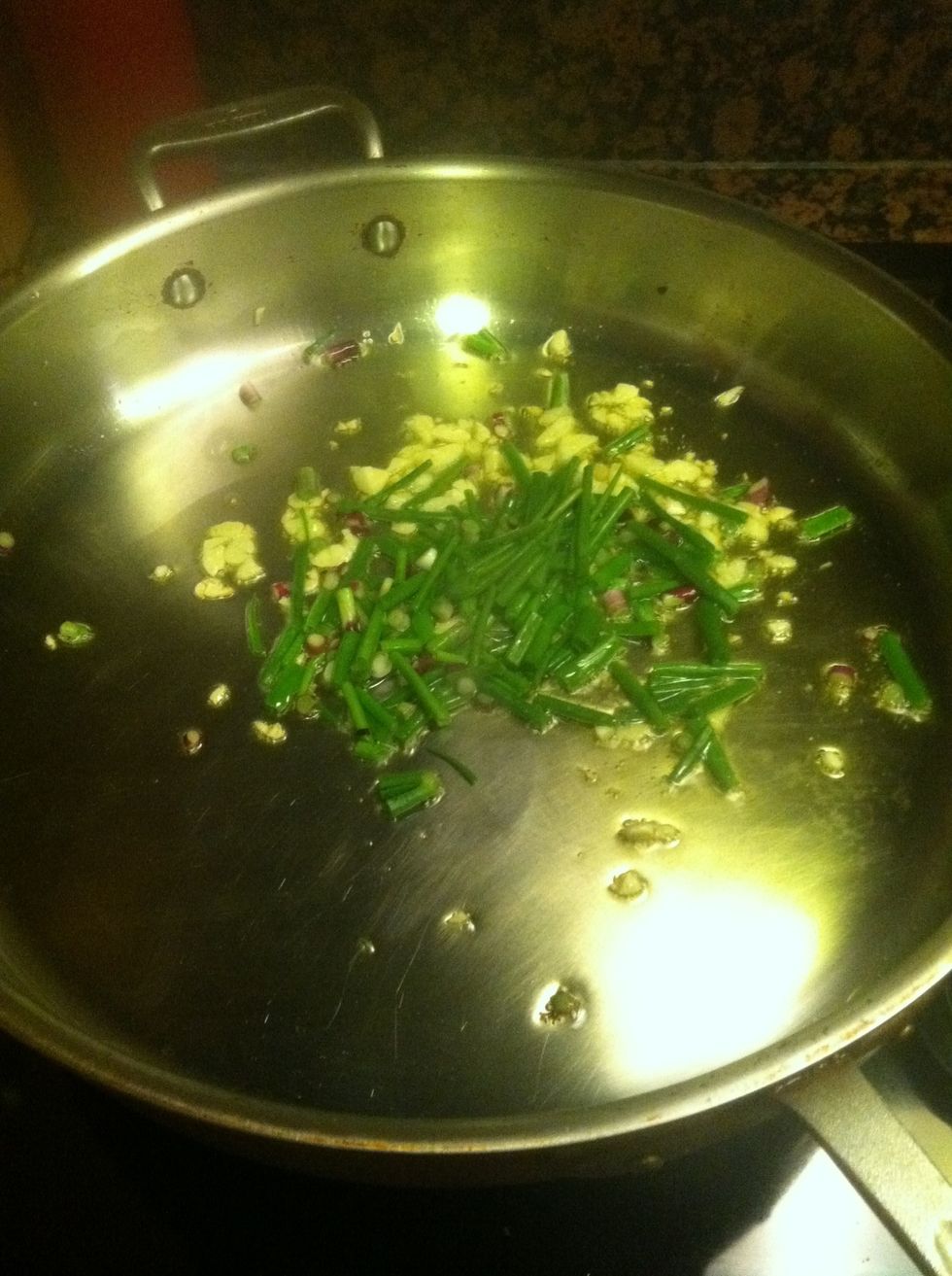 After a minute, and without letting the garlic start to toast, throw in the spring onions.