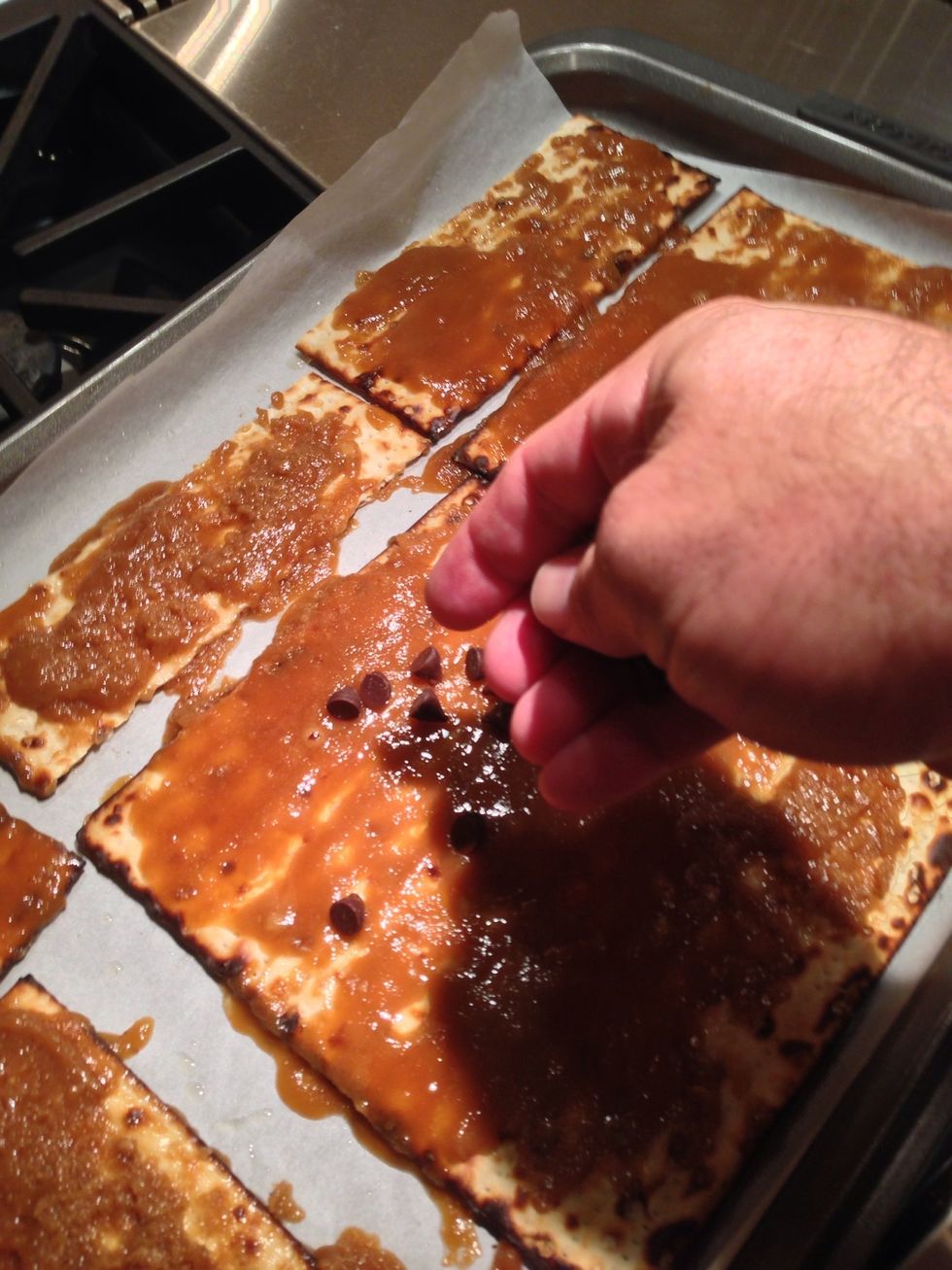 After a minute of cooling sprinkle chocolate chips all over the matzah. Like a boss.