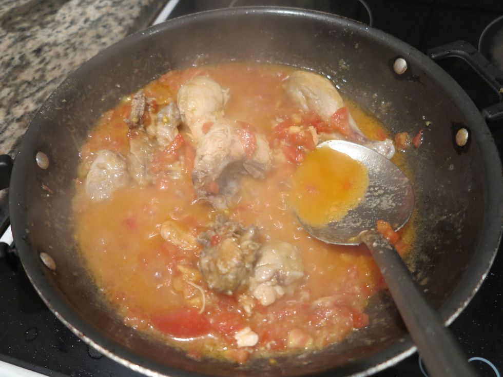 After a while, it should start looking like this. As the tomatoes start to cook, their water is drained which helps form the gravy. Cook on medium heat till the tomatoes soften up a little.