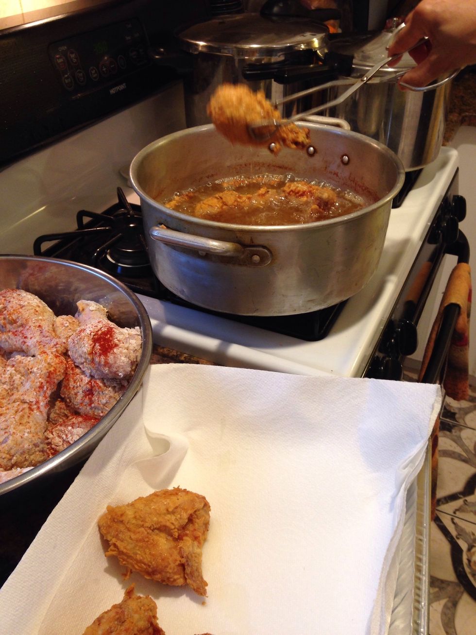 After about 15-20 minutes or until the chicken is browned and crisp to your liking remove from the oil. Place chicken into a pan that's layered with paper towel to absorb excess oil.
