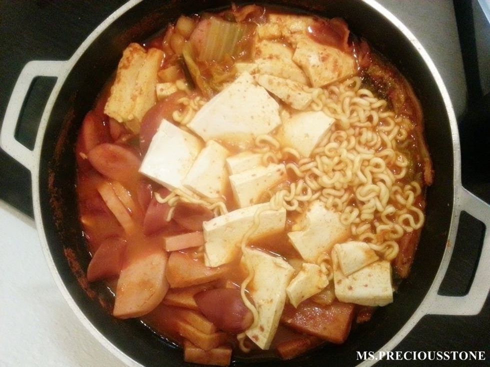 After about 15-20 minutes, put tofu and noodle into the pot. Wait until the noodle is softened, then stir to make sure everything is cooked evenly.