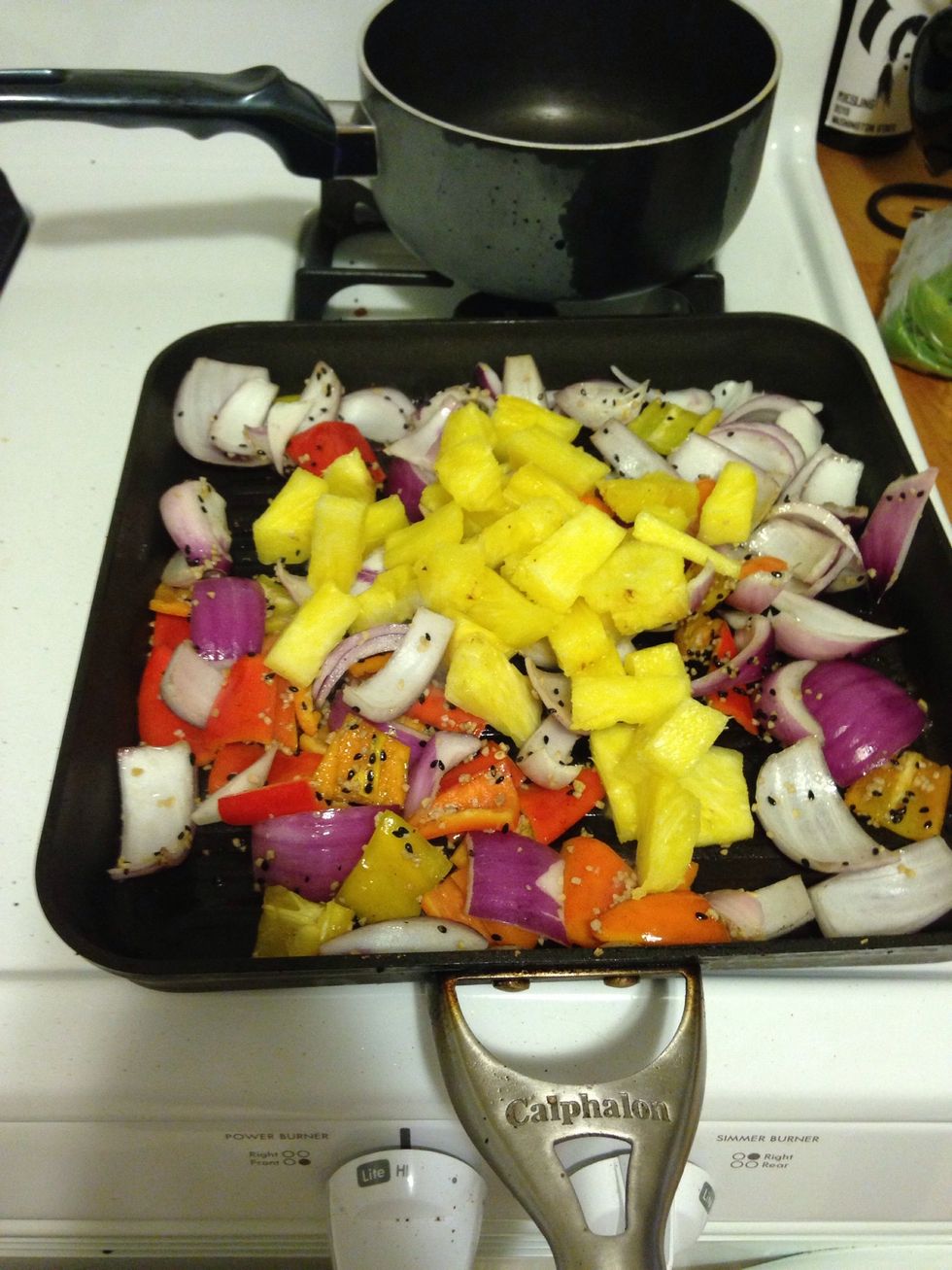 After about 5 minutes of cooking, add 1/2 cup of pineapple.