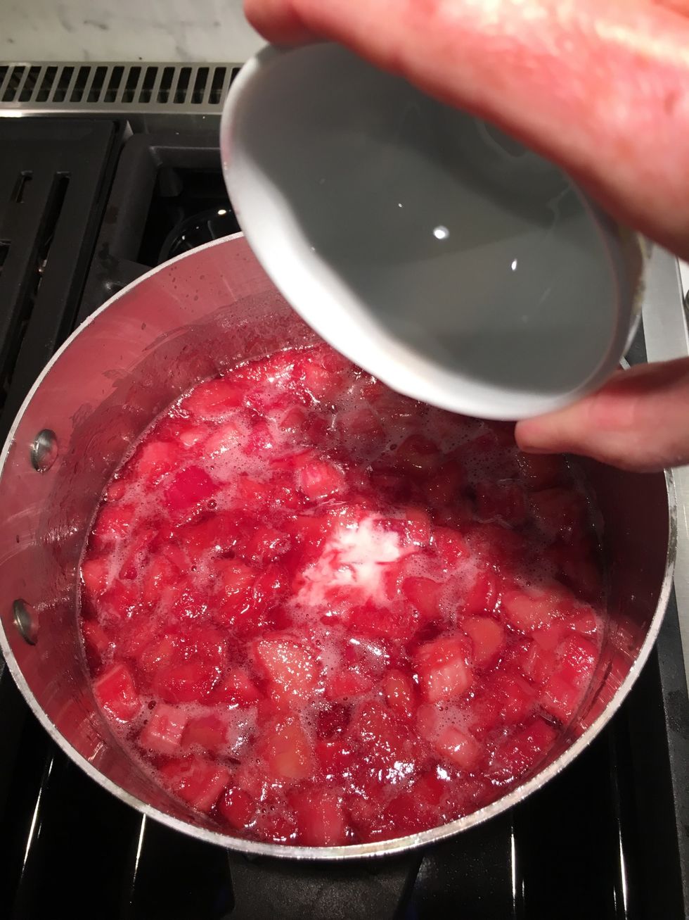 After about 5 minutes, the rhubarb will look like this. Pour in the cornstarch, stirring constantly. It will begin to thicken right away