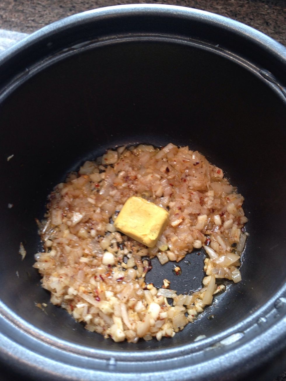 After about 6 or 7 minutes, add your stock cube to the rice cooker