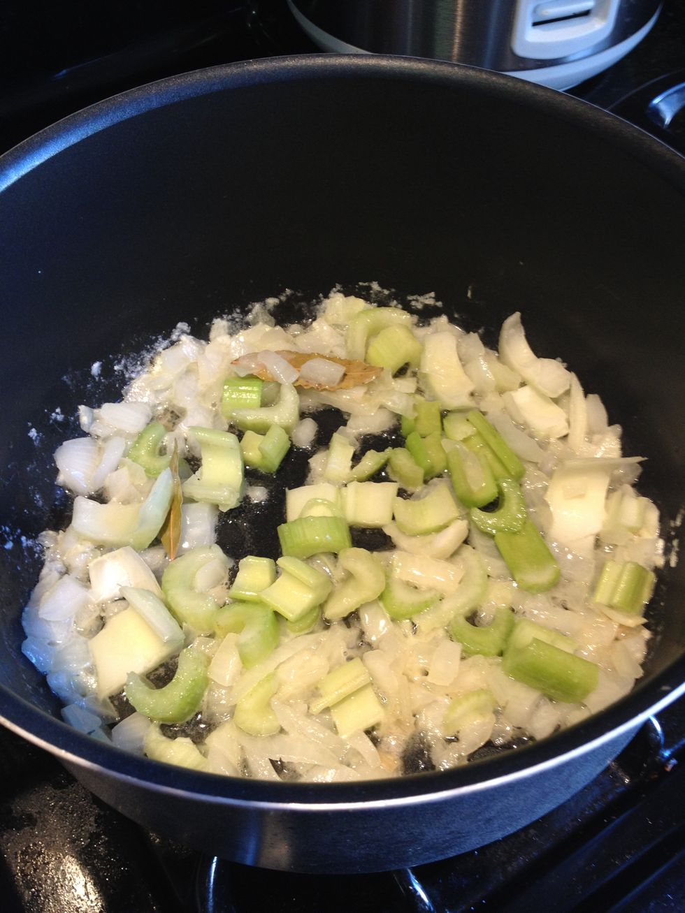 After about a minute, add the celery and mix it with the onions. This is a good time to add seasoning. Add poultry seasoning, salt and black pepper.