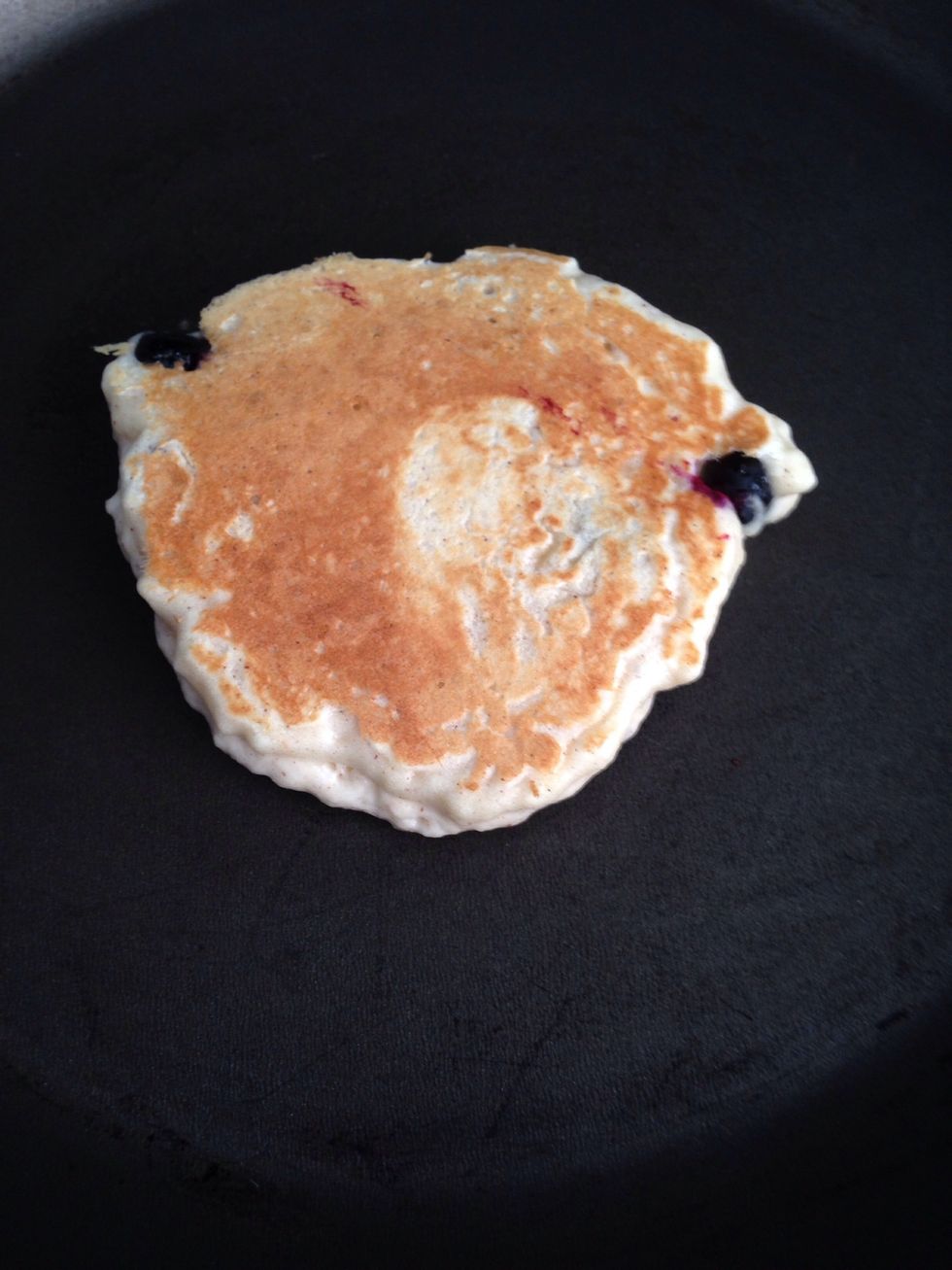 After about a minute, use a spatula to test the browning side of the pancake. If it peels up in one piece, give it a flip. The other side should be gently browned.