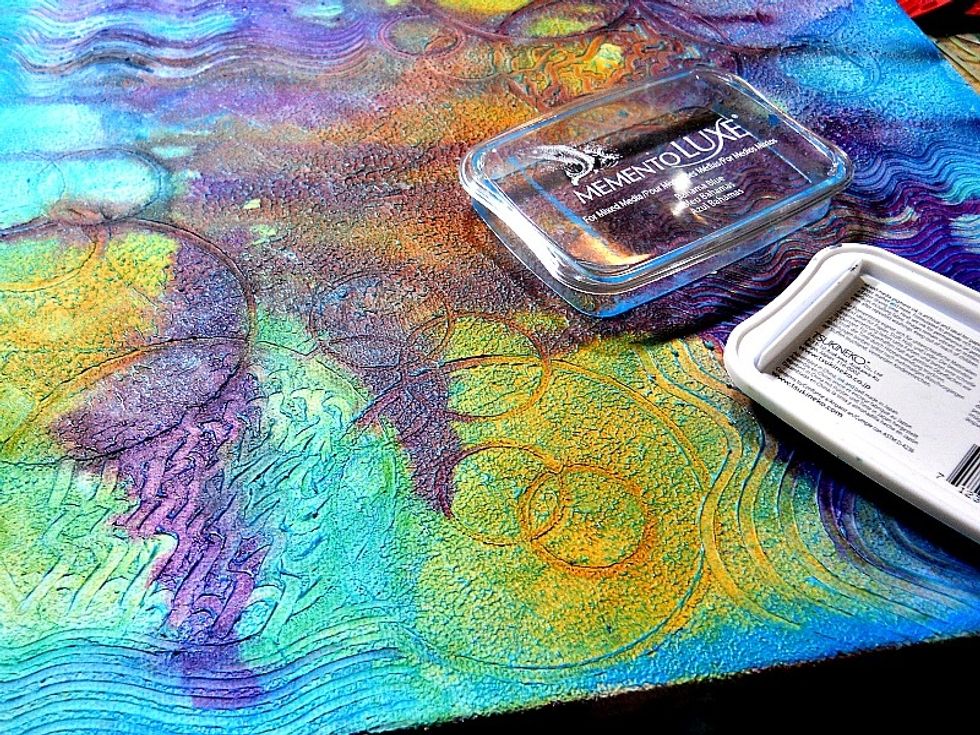 After all colors have dried completely, use a tsukineko memento luxe ink pad in "Bahama blue" to rub over the raised edges to make them pop.