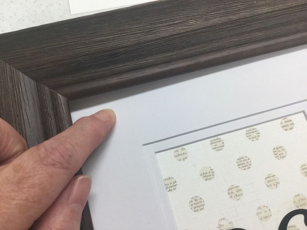 After all numbers are in place, you will add the custom rub-ons created earlier. You'll want to remove the mat from the frame and place on a firm surface before applying the rub-ons.