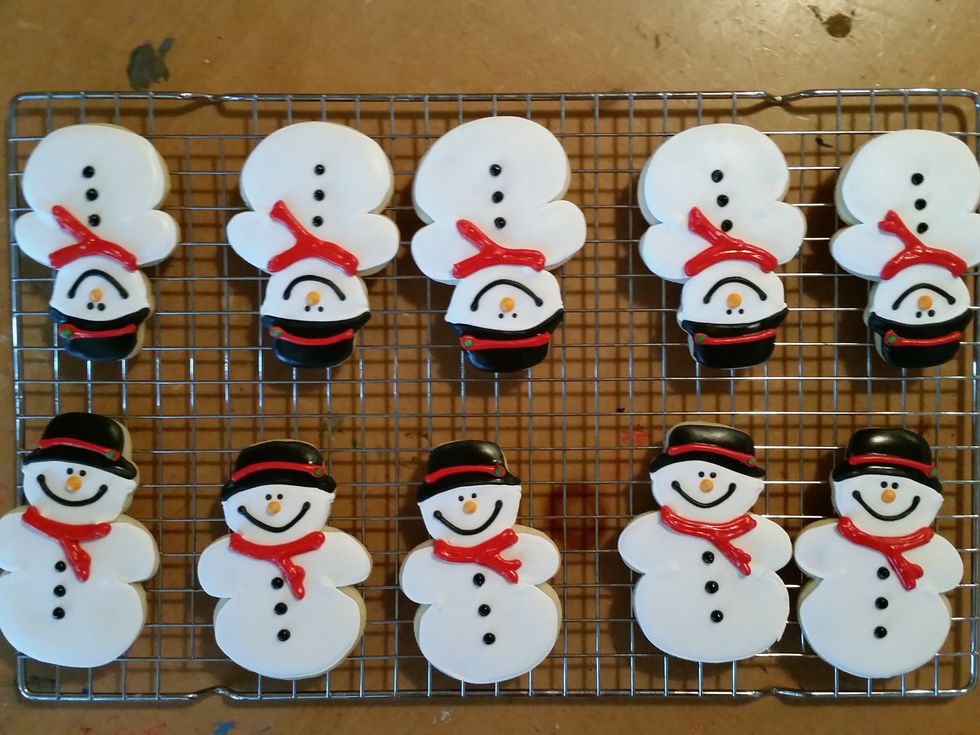 After all of your top cookies are decorated with details and completely dry. You're ready to assemble your Snowball Pooping Snowmen!