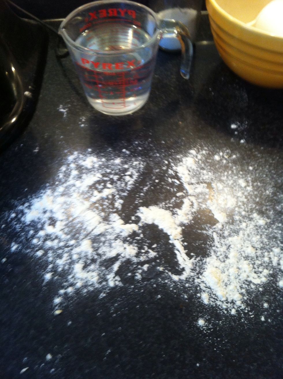 After all the flour is fully incorporated into the dough lightly flour a working surface and dump the dough out onto the surface. The dough will be VERY sticky and difficult to work with at first.