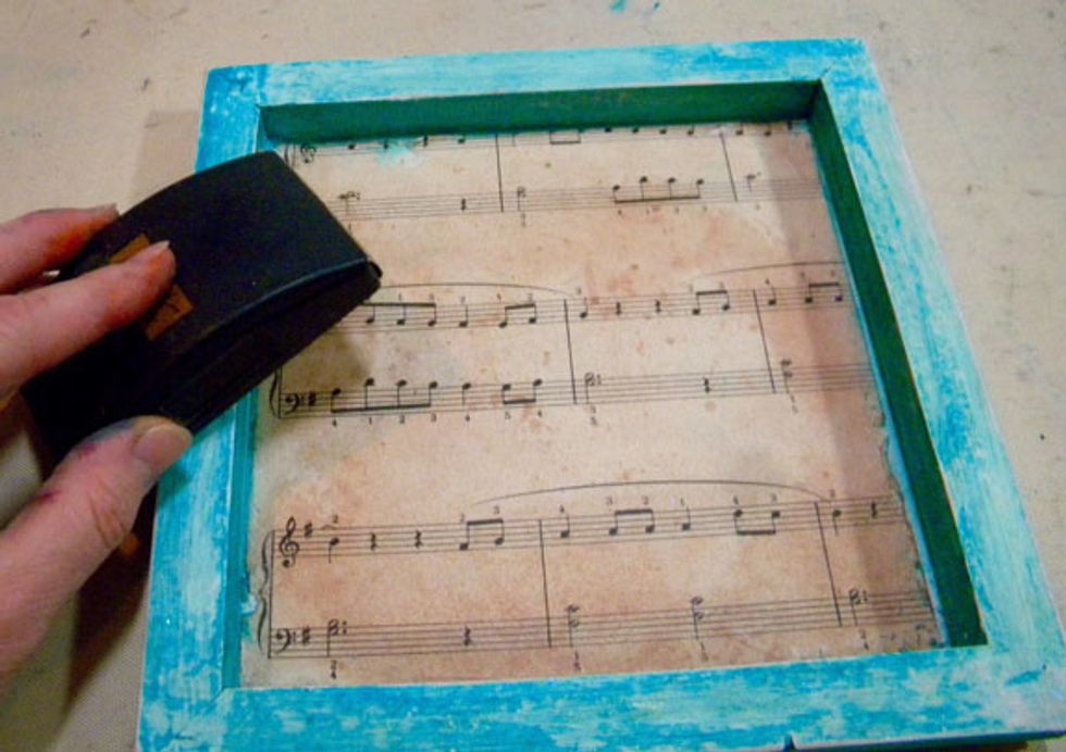 After all the paint is dry, sand the edges of each canvas.