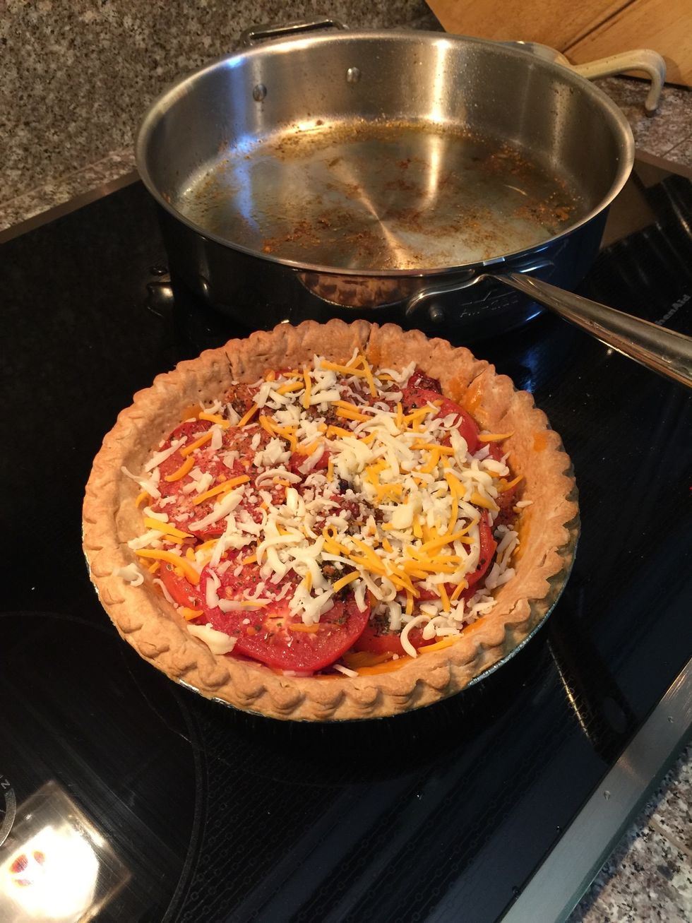 After all the tomatoes are in and the pan is all scraped clean, add the last of the cheese.