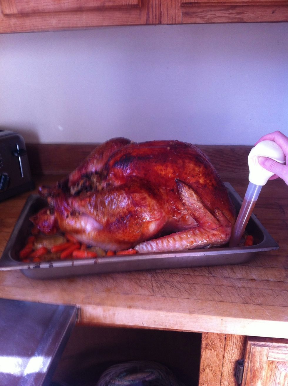 After an hour at 400+ degrees, the buttery skin is crisp, but the rest of the turkey needs another 4 hours at 350 degrees.