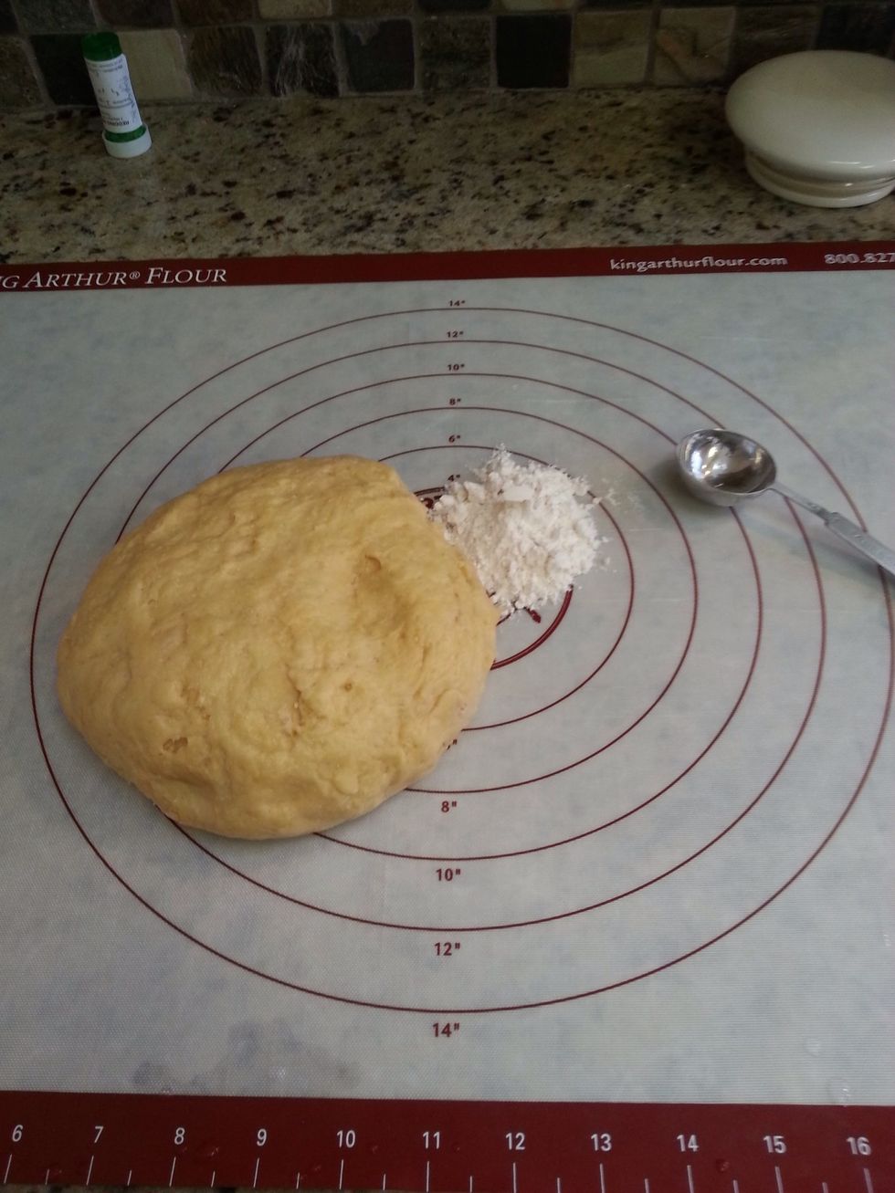 After an hour deflate the risen dough and knead about 2 tablespoons of flour into it