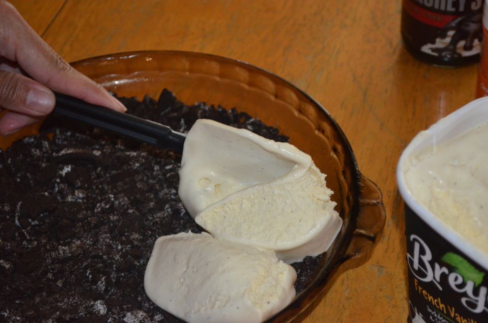 After an hour, take the pie plate out of the freezer and spread out your ice cream on the Oreos. Make sure the ice cream is defrosted though