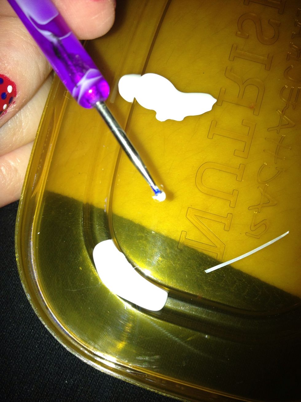 After background color is dry get second color and use dotting tool to dot on nail