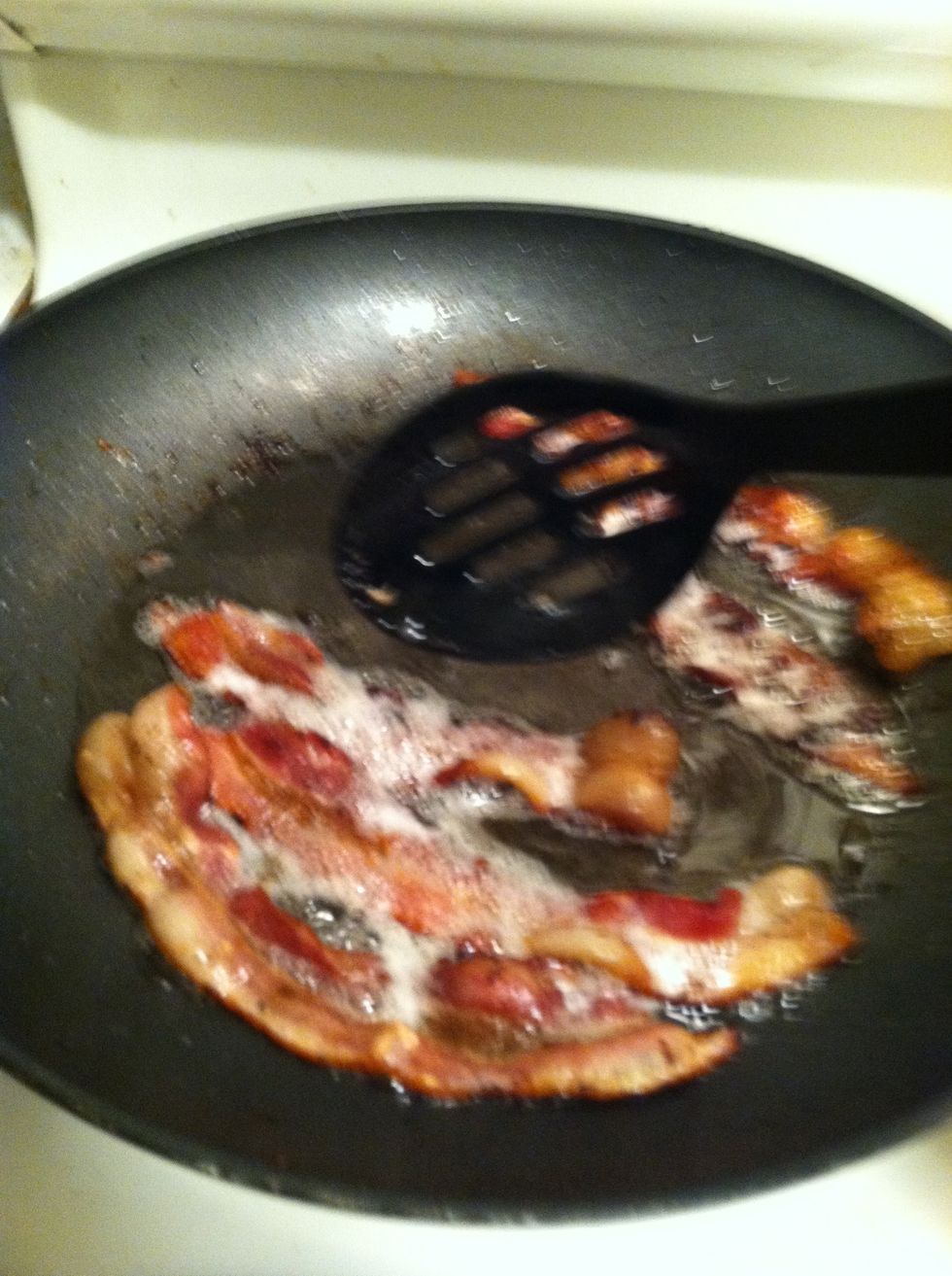 After bacon has cooked for 5-7 minutes (as stated in the previous step), check to make sure bacon is cooked on both sides. By now, it should look like the photo above.