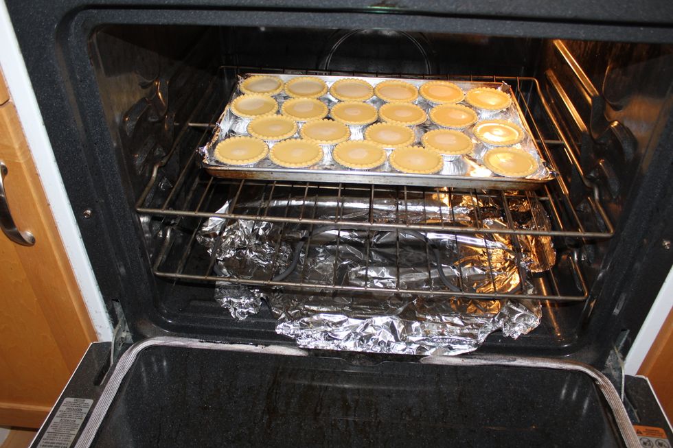 After, bake the raw egg tarts for 15 to 20 minutes at 400\u00b0F until golden brown. Don't forget that the oven is hot!