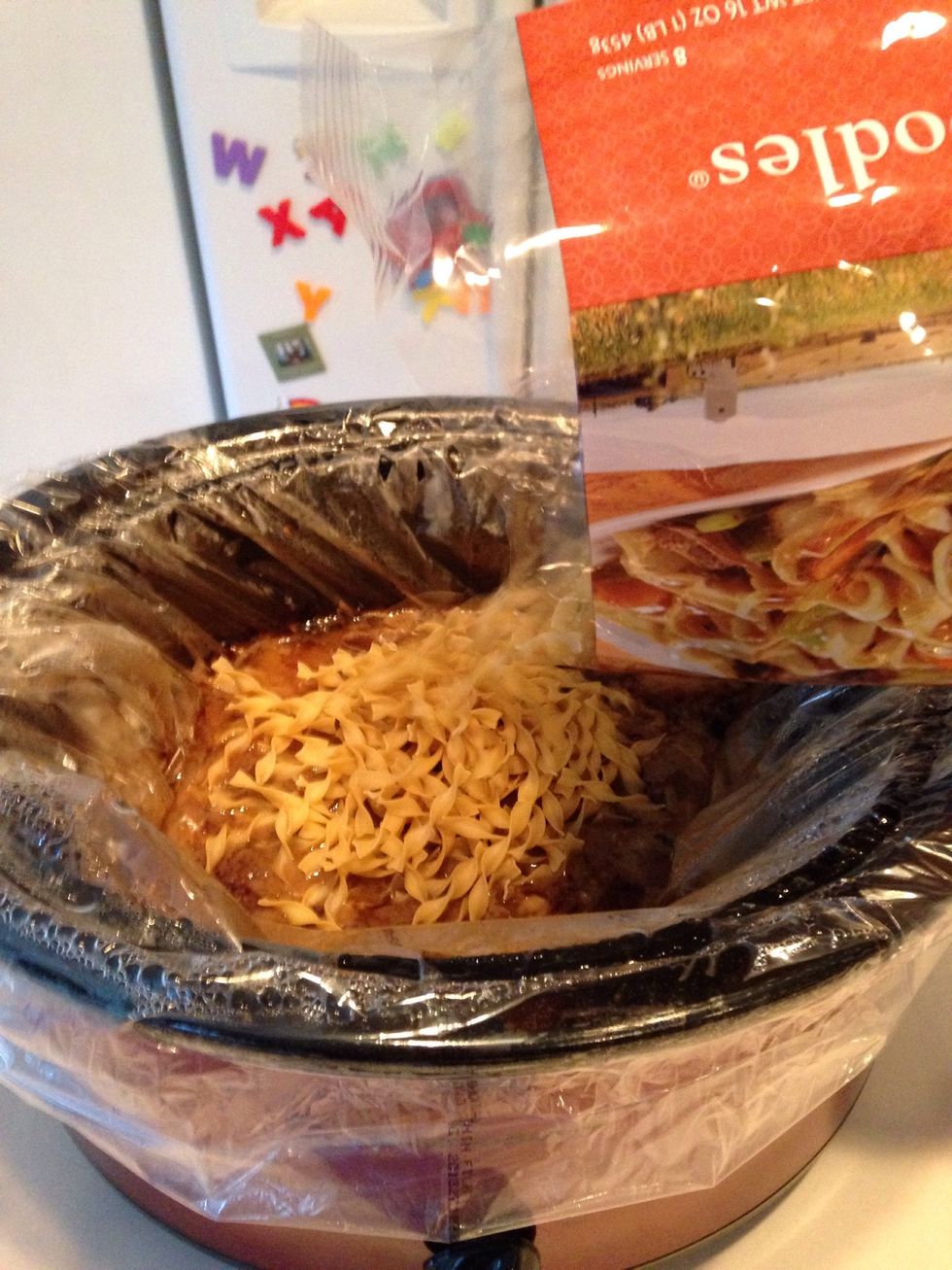 After beef is cooked, remove lid and add entire package of noodles.