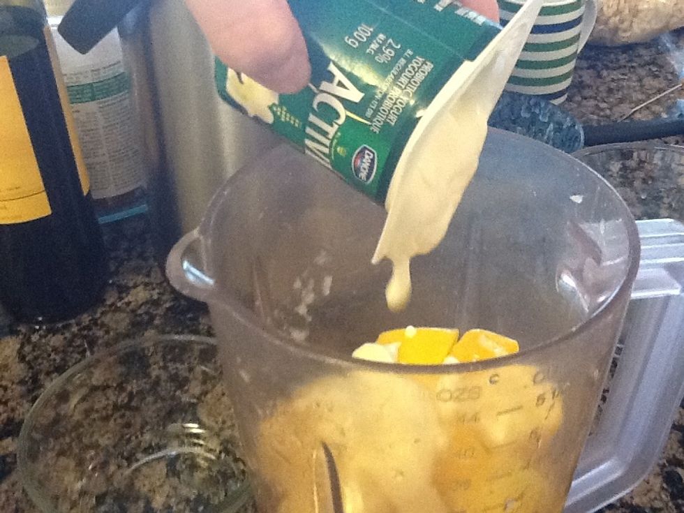 After blending for a while, start adding the yogurt. Keep blending till smooth.