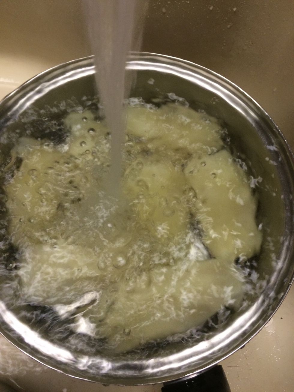 After boiling cool the potatoes by running cold water over them