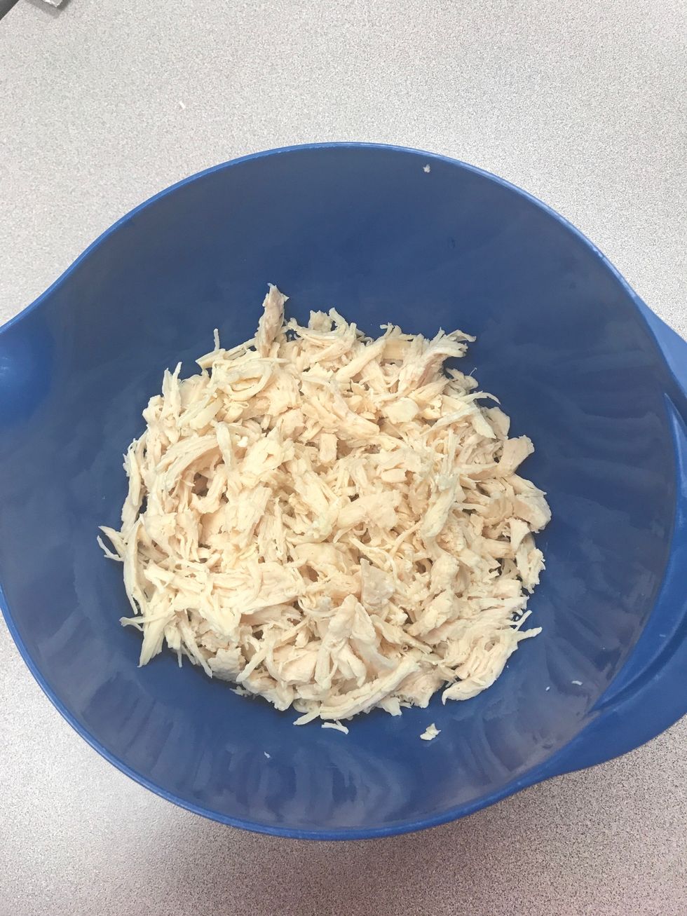 After chicken is fully cooked and cooled, shred chicken