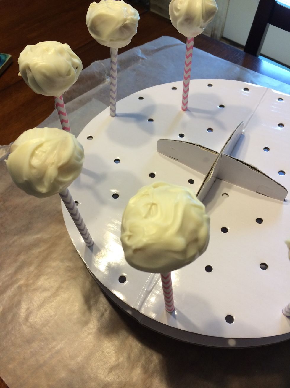 After chocolate is spooned onto cakepop