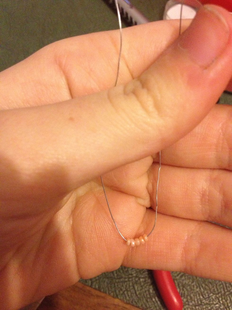 After choosing your main colour put 5 beads onto about 1m of beading wire. Make sure they are in the middle of your wire.
