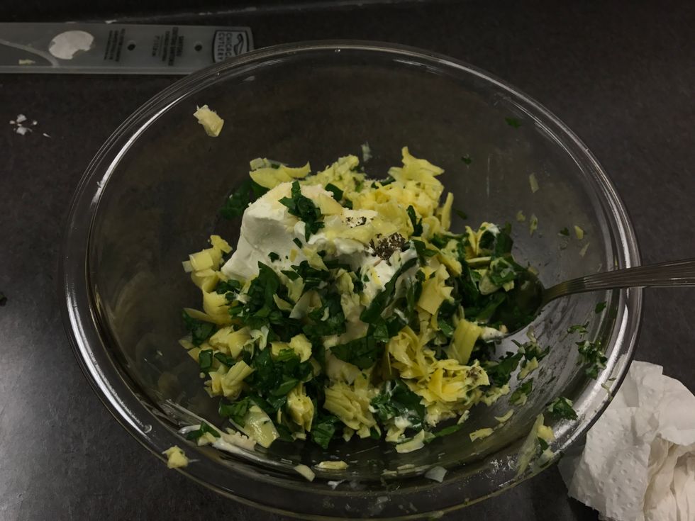 after chopping up the spinach and artichoke hearts add in the measured ingredients such as the cream cheese, mayonnaise, grated Parmesan & Romano cheese, garlic, dried basil, salt and pepper & mix