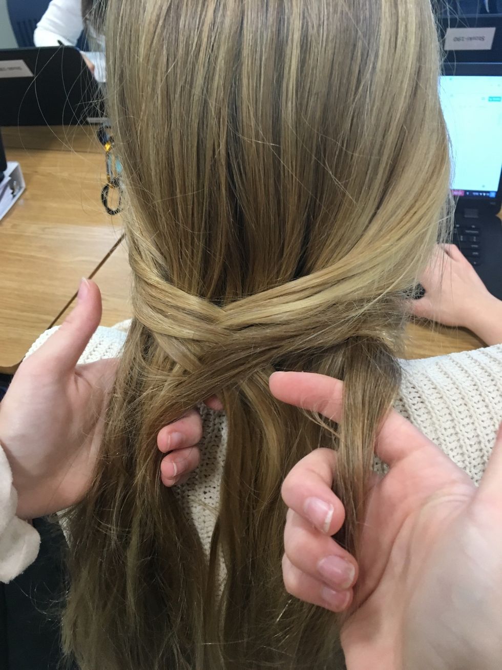 After completing step 3, you will need to do the opposite and grab a small piece of hair from the far end of the right side over to the inside of the left half of hair.