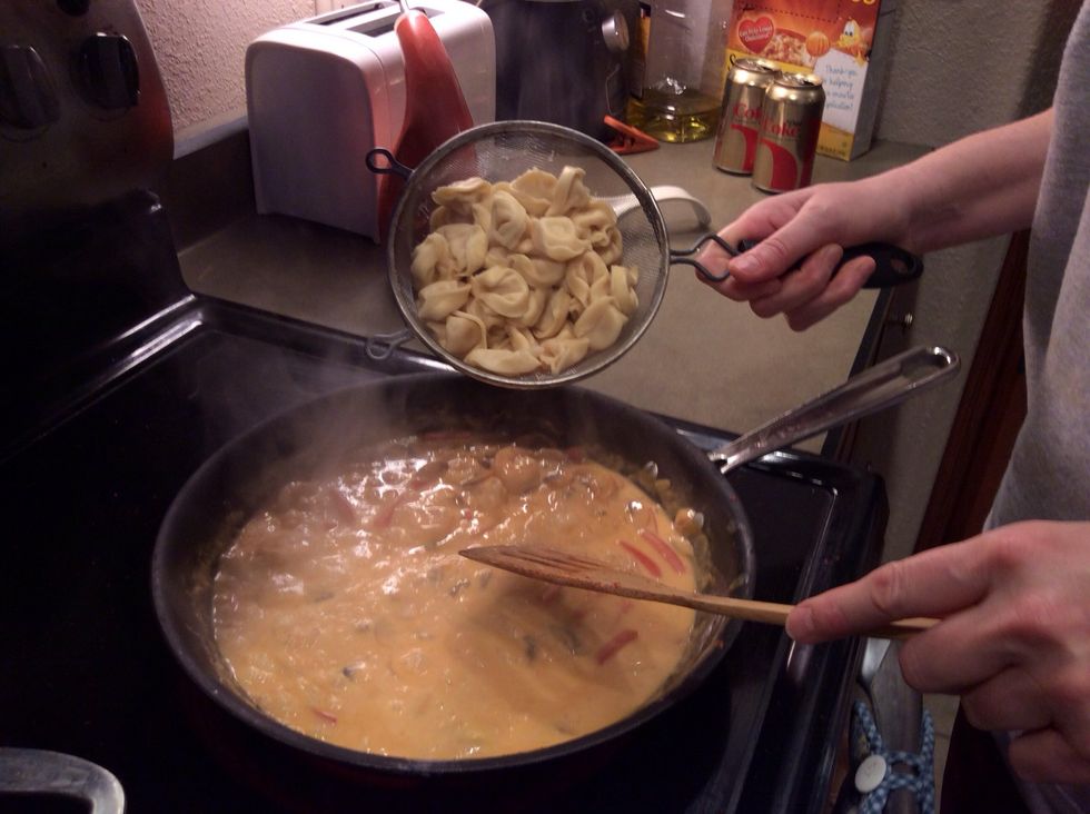 After cooking red peppers and onions for a couple of minutes add your cooked tortellini.