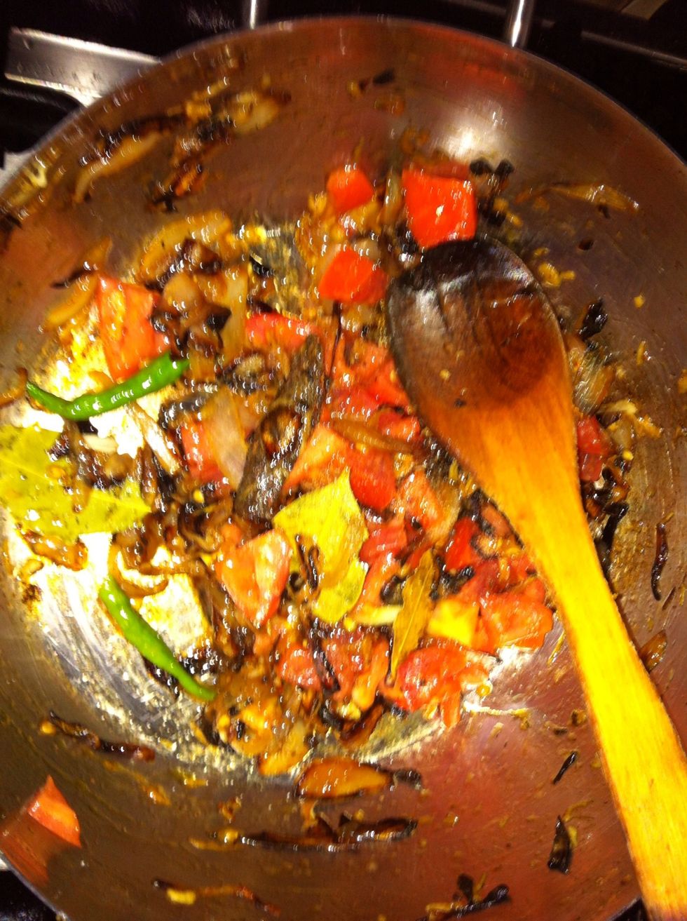 After cooking the garlic and ginger for about a minute, add the chillies ( i love spicy food ) and the diced tomatoes.