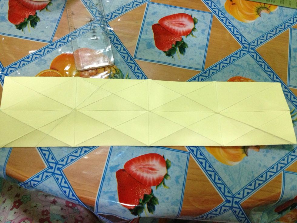 After creasing it all, turn the paper over. It should look like this. Tap the photo to see the whole picture.